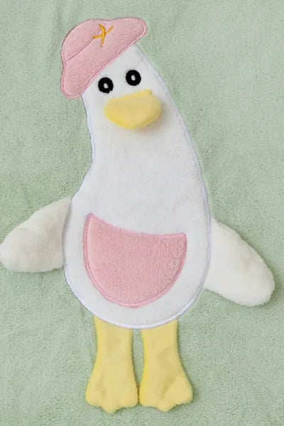 A close-up of a soft, Green towel with a white and blue duck applique.