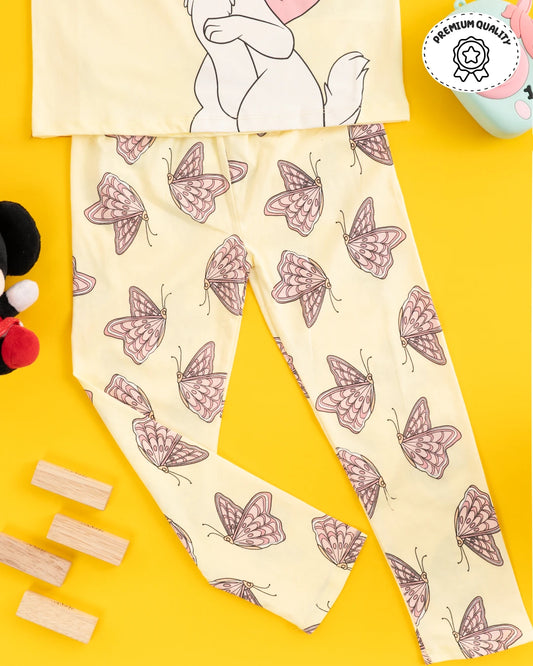 Trending clothes for girls featuring a playful cat and butterfly design on a yellow top and pants. Girls kids clothing, girls fashion, girls wear