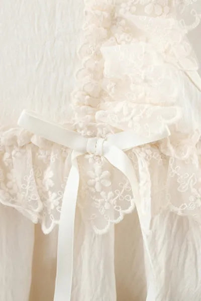 A fashionable white dress with an attached straw-like purse for girls, a popular choice in trending clothes for girls.
