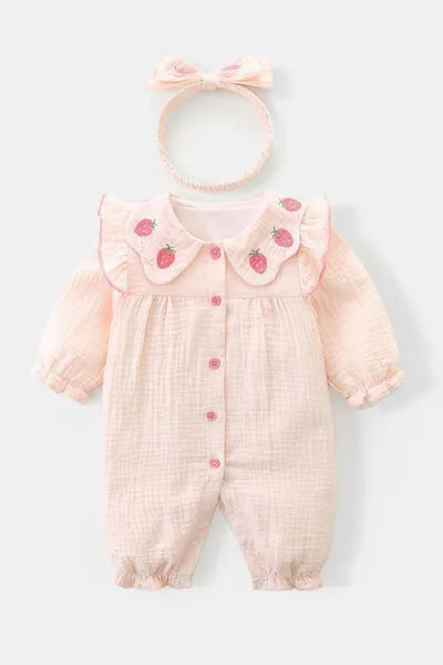 A charming light pink baby romper with a scalloped strawberry collar and matching headband, a trendy item in girls fashion and suitable as new born cloths for a baby.

