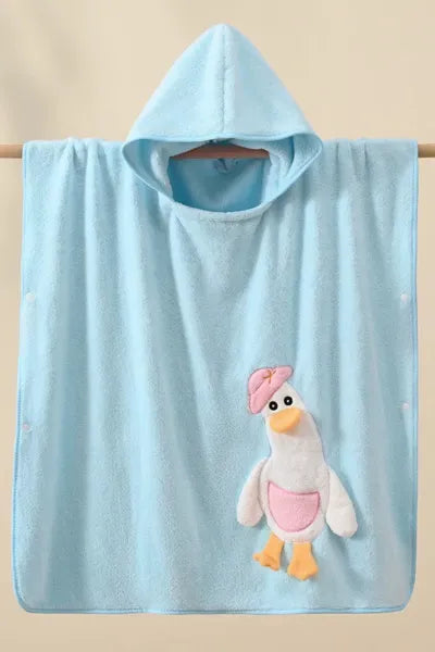 A soft, hooded blue towel with a white and blue cartoon duck applique hanging from a wooden rod