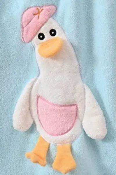 A close-up of a soft, blue towel with a white and blue duck applique.