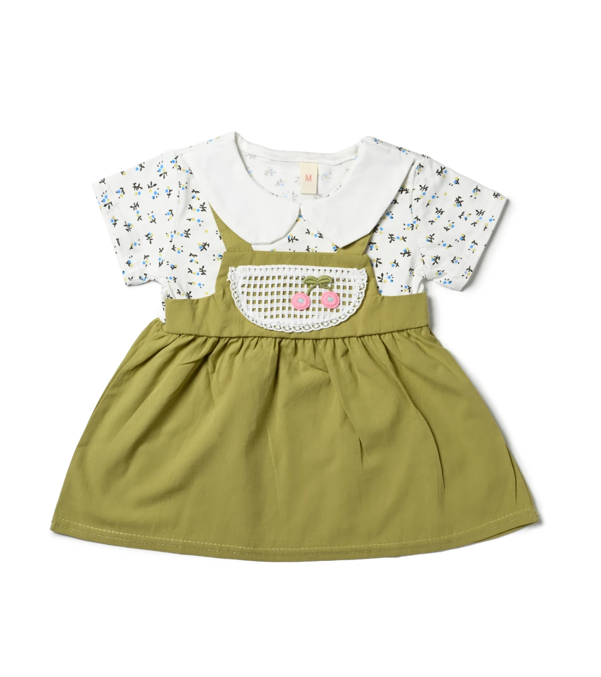 A stylish outfit from girls kids clothing: a green dress with a white top and teddy bear accent