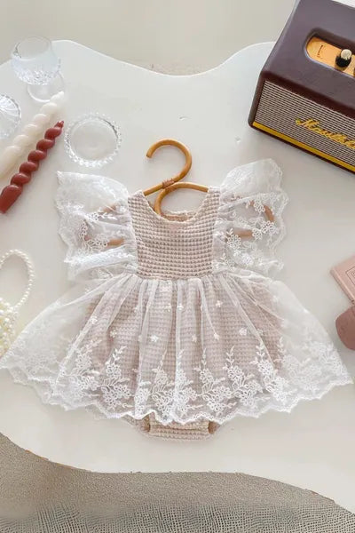 A fashionable cream lace romper for girls, a must-have in trending clothes for girls