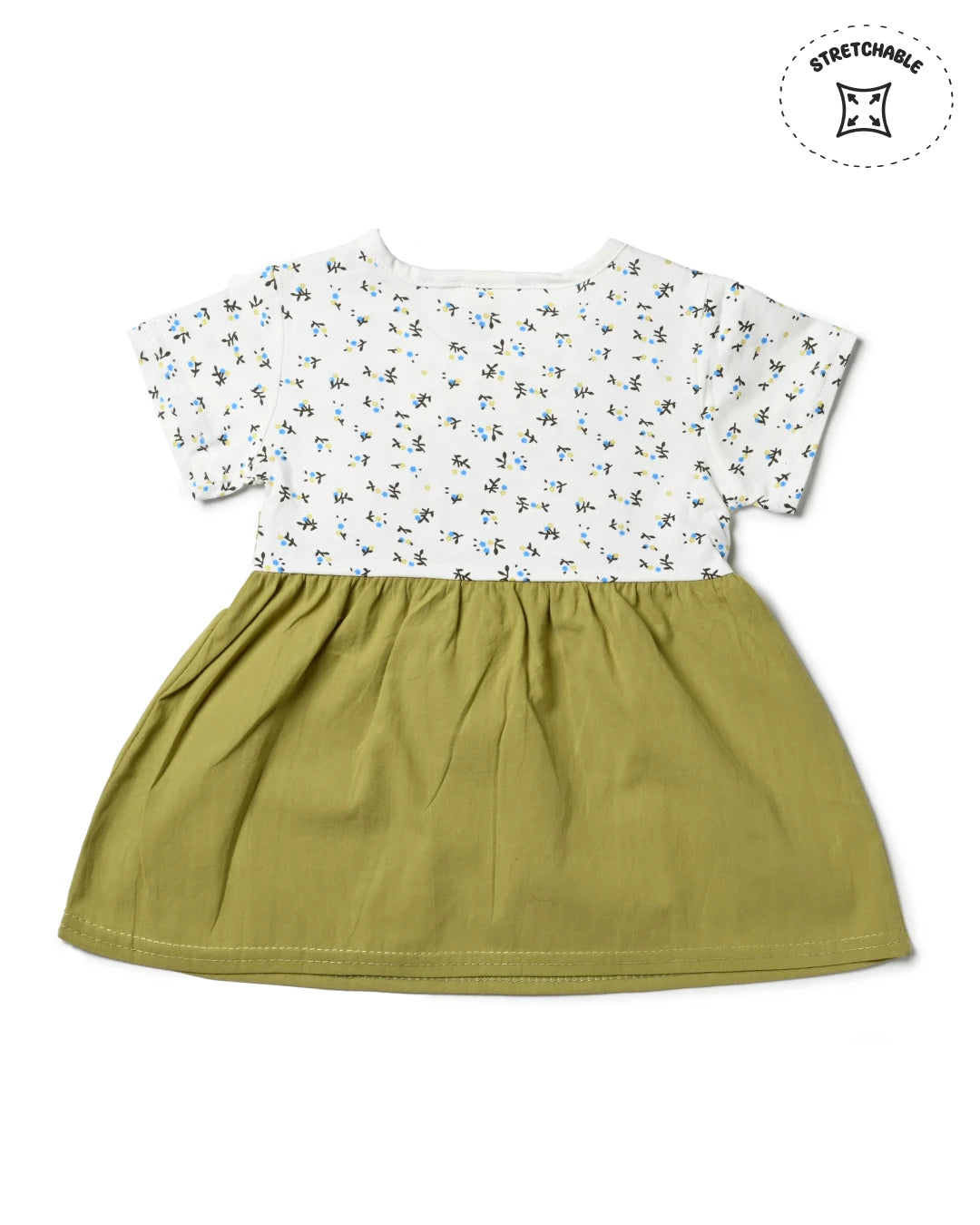 A cute green overall dress with a white t-shirt underneath, a trendy piece of girls fashion