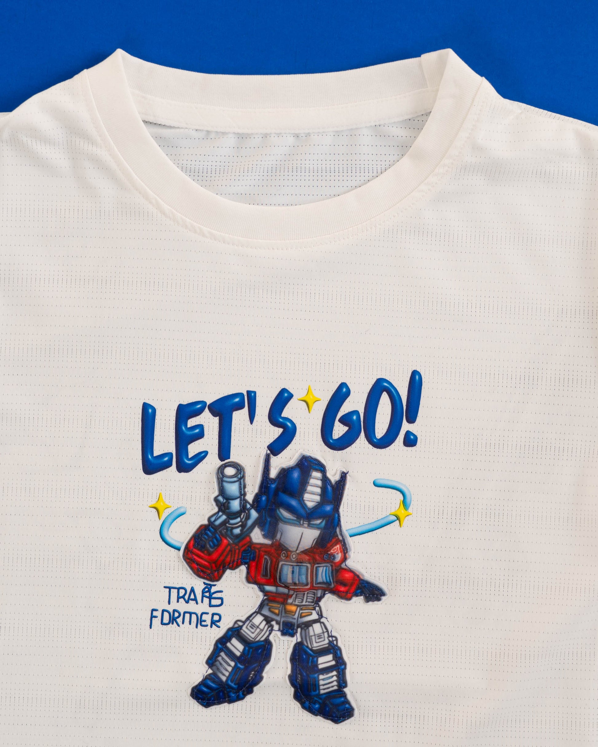 Kids' white t-shirt featuring Optimus Prime in action.
