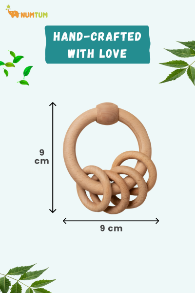 Wooden teething ring with dimensions and 'Hand-Crafted with Love' text on a white background with green leaves.