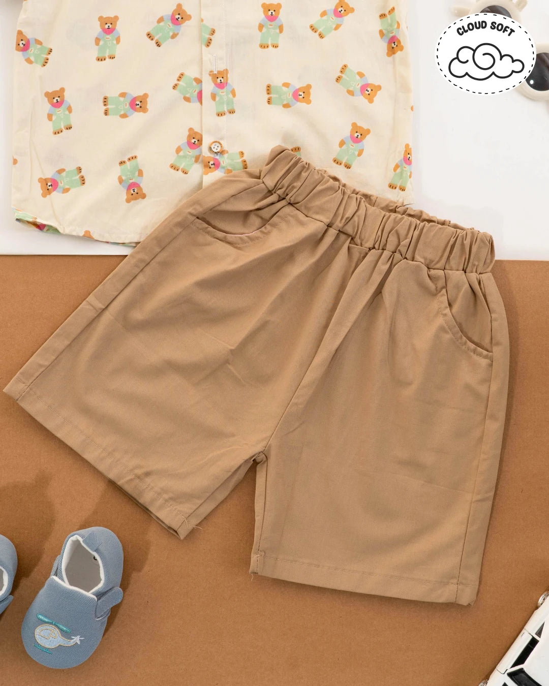 Boys dress style: trendy summer attire with beige shorts and a patterned shirt. Kids clothes boys, kids dress for boys