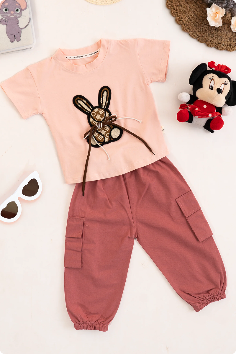 Girls kids clothing featuring a pink bunny t-shirt and matching pink cargo pants. Girls fashion, girls wear, trending clothes for girls