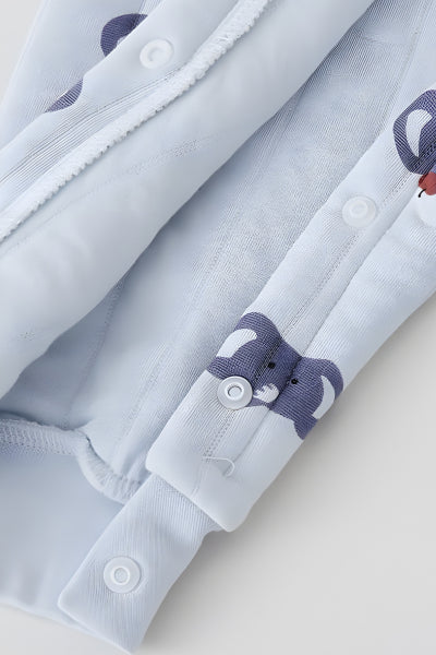 Close-up of a baby outfit with bear designs on buttons and collar.