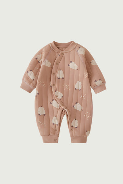 Pink baby onesie with sheep pattern on a light beige background