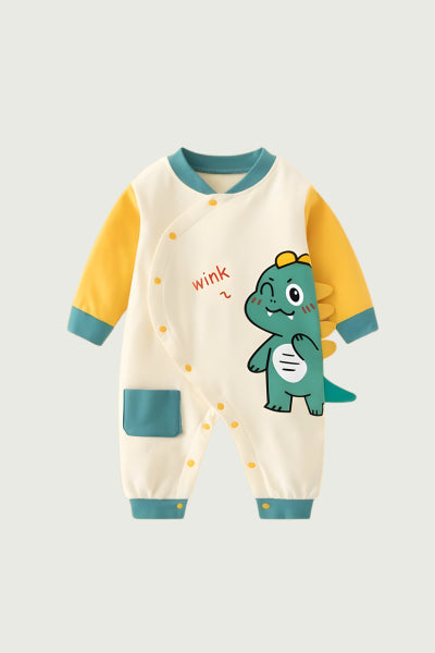 "Cream colored baby romper with green dinosaur print design, perfect for active crawlers and toddlers"