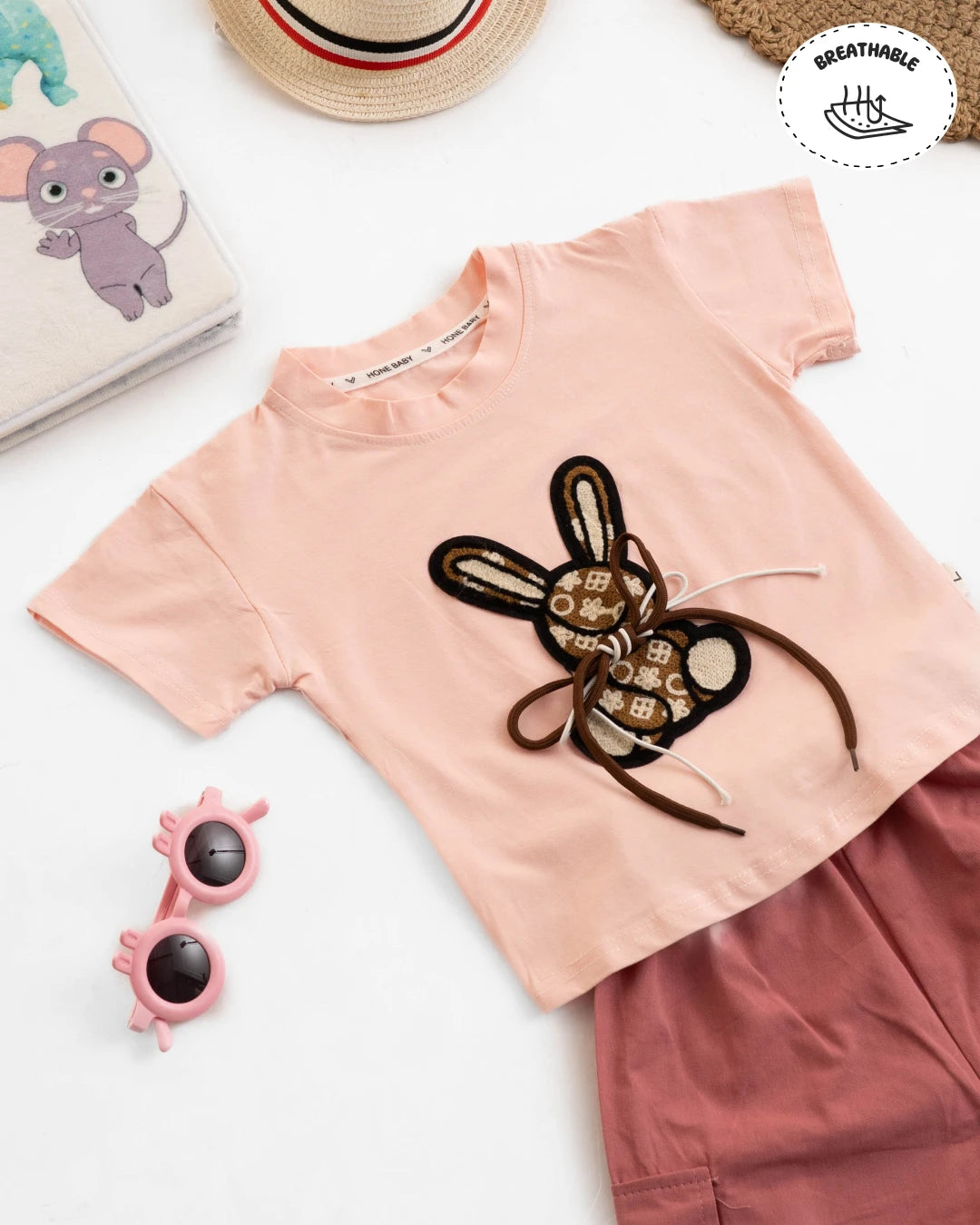 Fashionable girls outfit: light pink tee with a bunny print and dusty rose cargo pants. Girls fashion, girls shopping