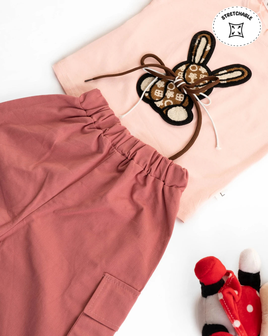 Latest fashion for girls: cute bunny t-shirt paired with stylish pink cargo pants. Girls kids clothing, girls shopping